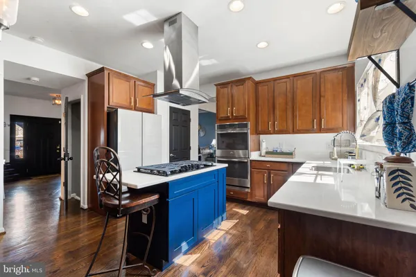 a kitchen with a sink a counter top space appliances and cabinets