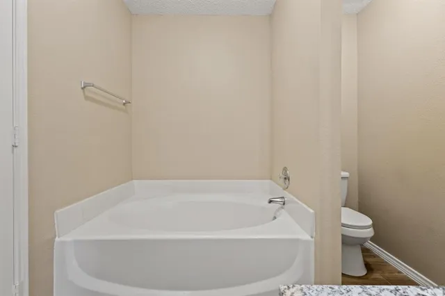 a white bath tub sitting next to a white toilet