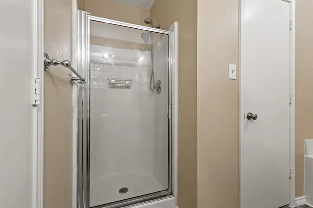 a bathroom with a glass shower door