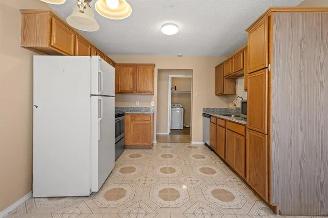 a kitchen with stainless steel appliances a refrigerator and a stove