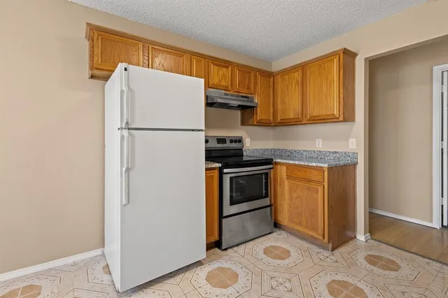 a kitchen with a refrigerator sink and stove