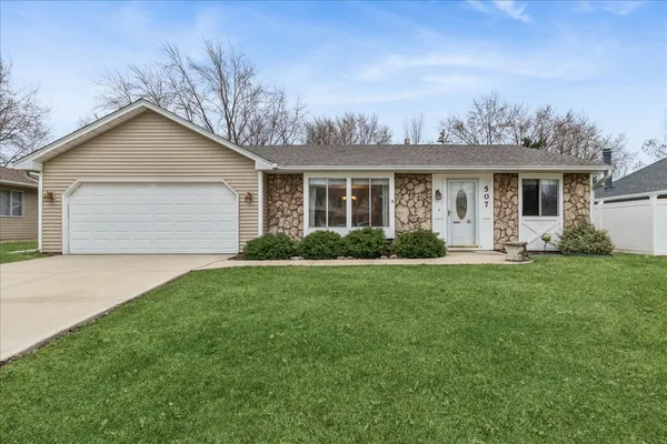 a front view of house with yard and green space