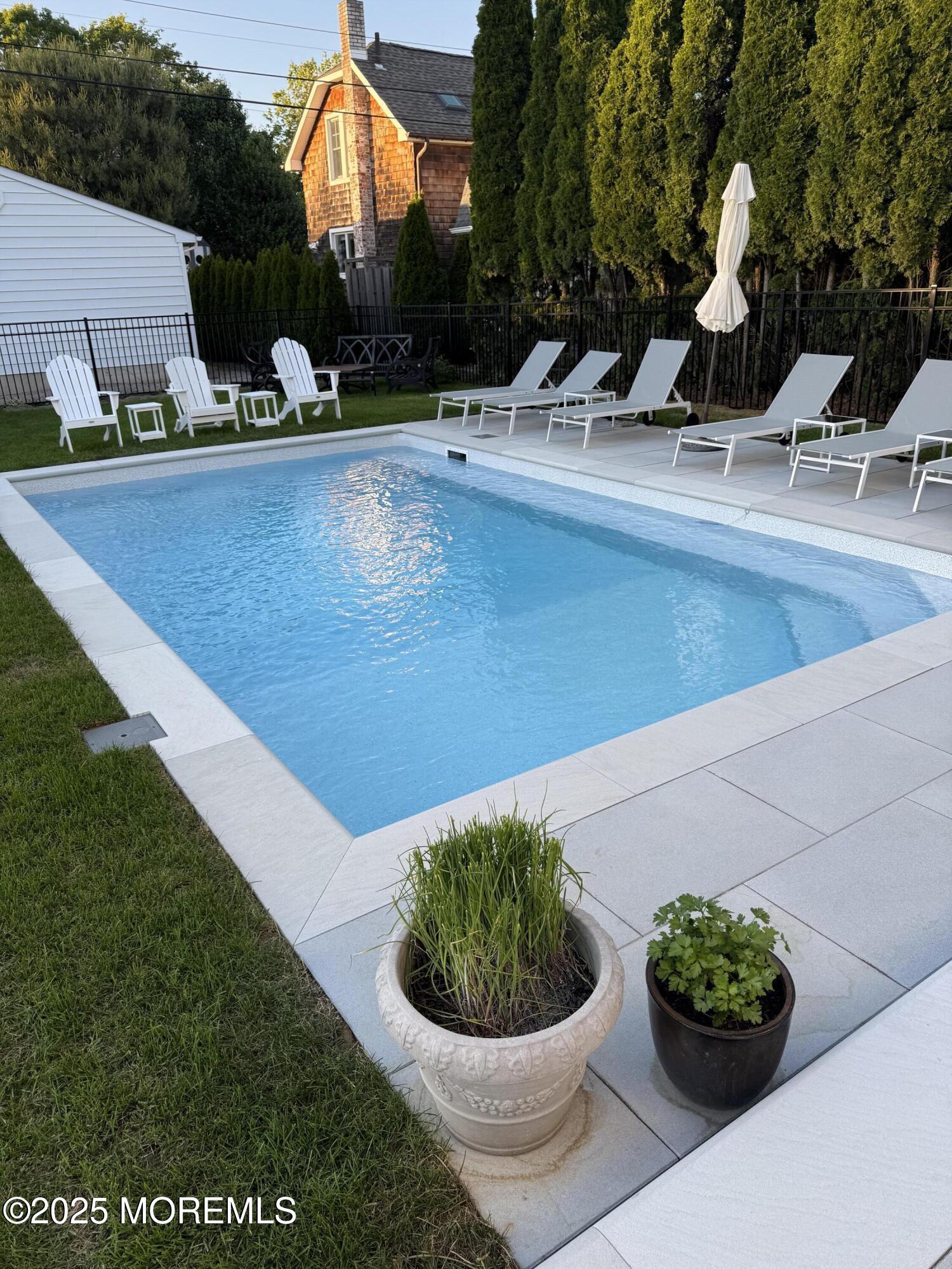 502 Tuttle Avenue Spring Lake, NJ 07762 - Photo 3 of 36 a view of a fountain with potted plants