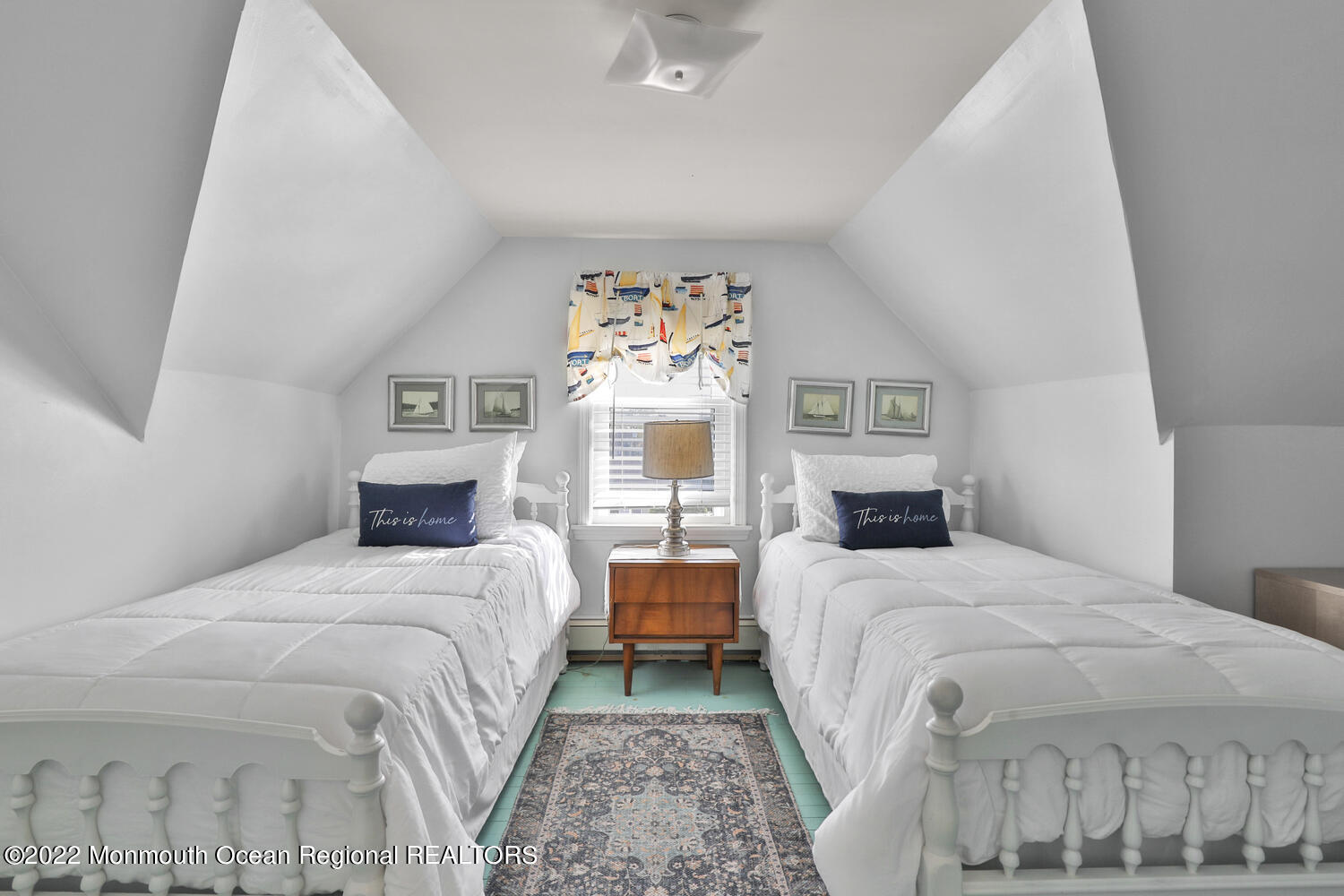 502 Tuttle Avenue Spring Lake, NJ 07762 - Photo 32 of 36 a bedroom with two beds and a chandelier