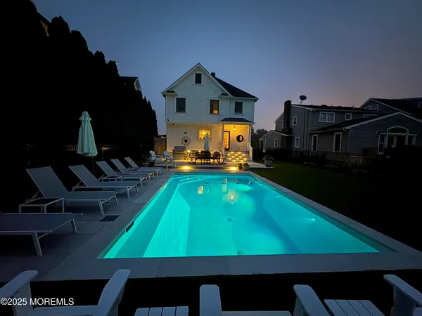 a room with pool table and chairs