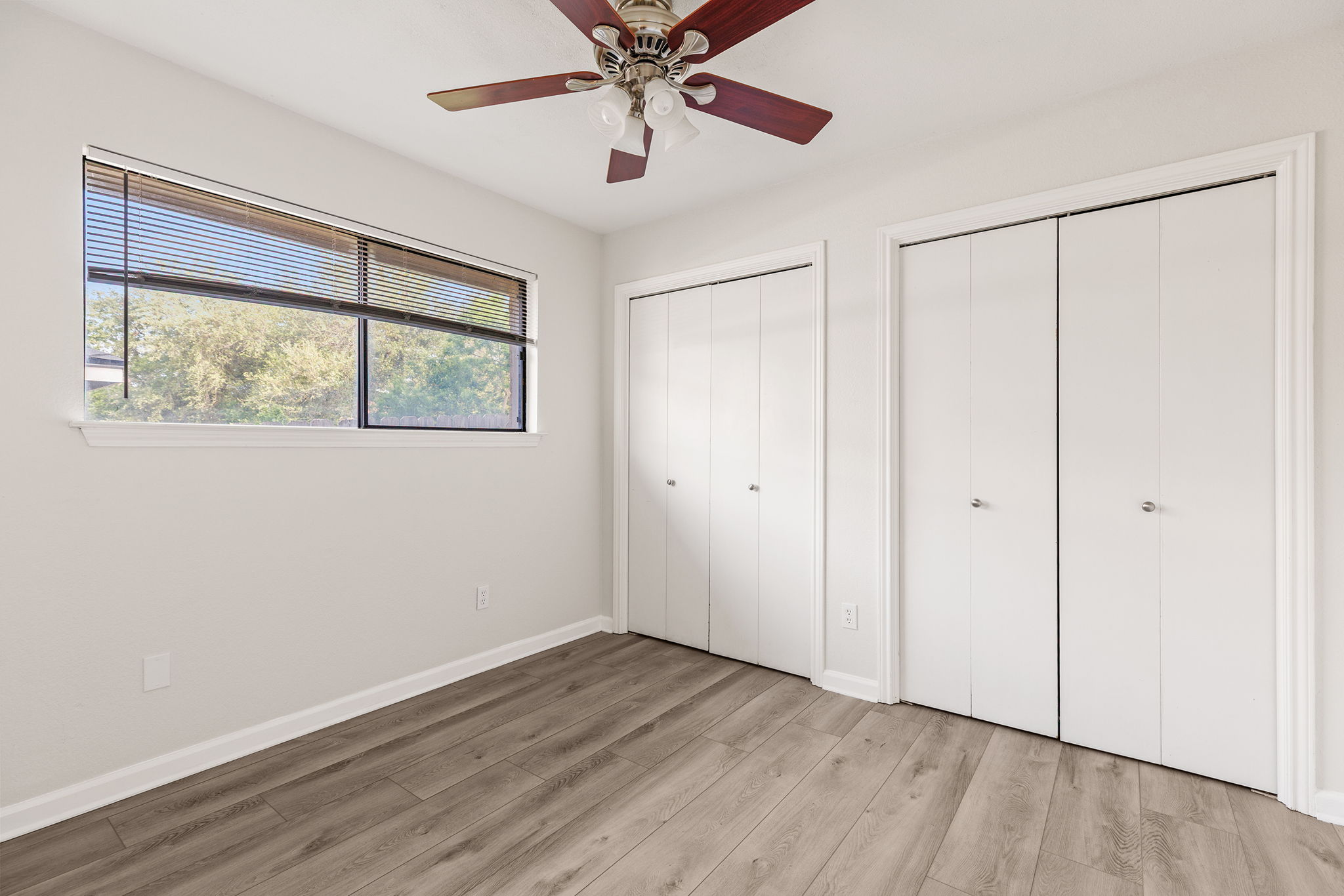 2409 Water Well Lane Austin, TX 78728 - Photo 16 of 22 Room featuring wood-finish flooring, a ceiling fan with light fixture, and a large window with blinds