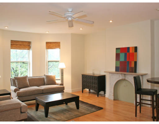 114 West Concord Street, Unit 2 Boston, MA 02118 - Photo 1 of 9 a living room with furniture a fireplace and a large window