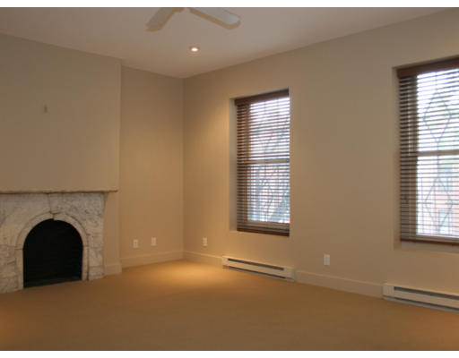 114 West Concord Street, Unit 2 Boston, MA 02118 - Photo 6 of 9 a view of an empty room with a fireplace and a window