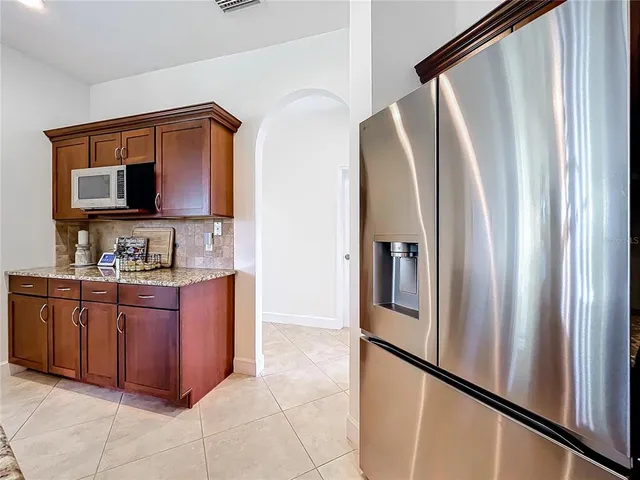 a large kitchen with stainless steel appliances granite countertop a stove and a sink