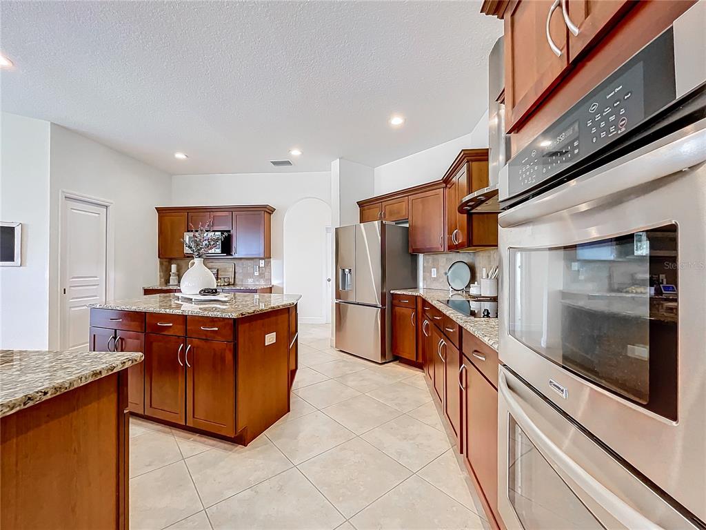 275 Cr 552 Bushnell Bushnell, FL 33513 - Photo 14 of 69 a large kitchen with stainless steel appliances granite countertop a stove and a sink