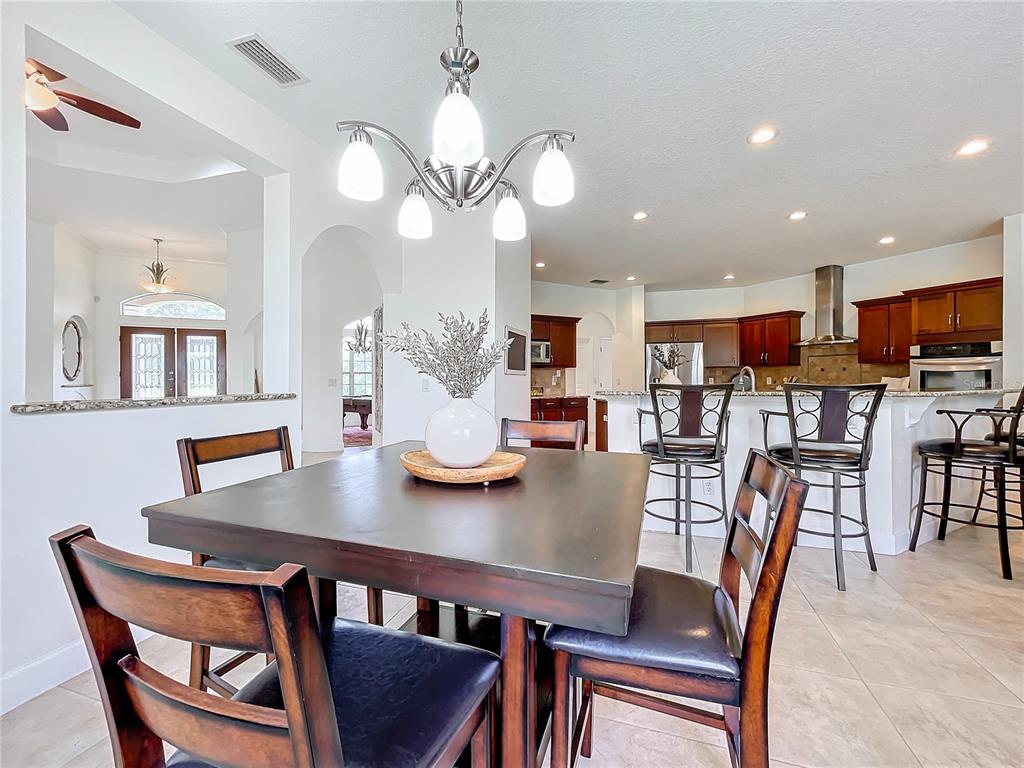 275 Cr 552 Bushnell Bushnell, FL 33513 - Photo 17 of 69 a view of a dining room with furniture and wooden floor
