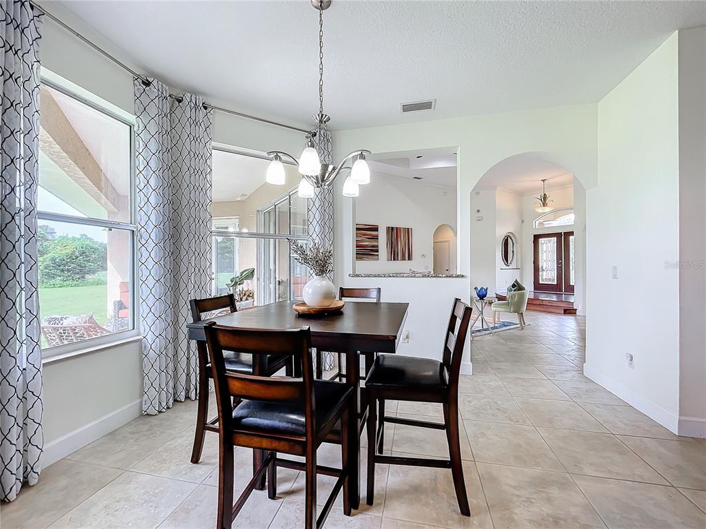 275 Cr 552 Bushnell Bushnell, FL 33513 - Photo 18 of 69 a view of a dining room and livingroom with furniture window and wooden floor