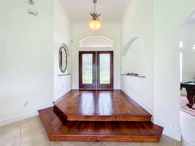 a living room with furniture a rug and a chandelier
