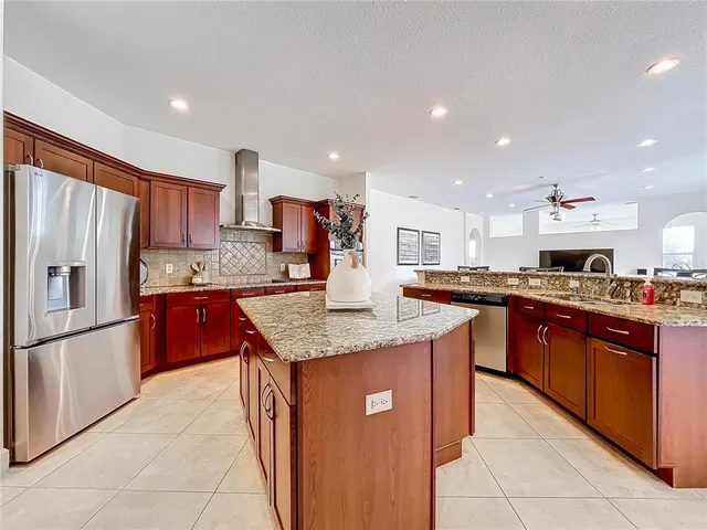 a kitchen with stainless steel appliances granite countertop a refrigerator and a sink
