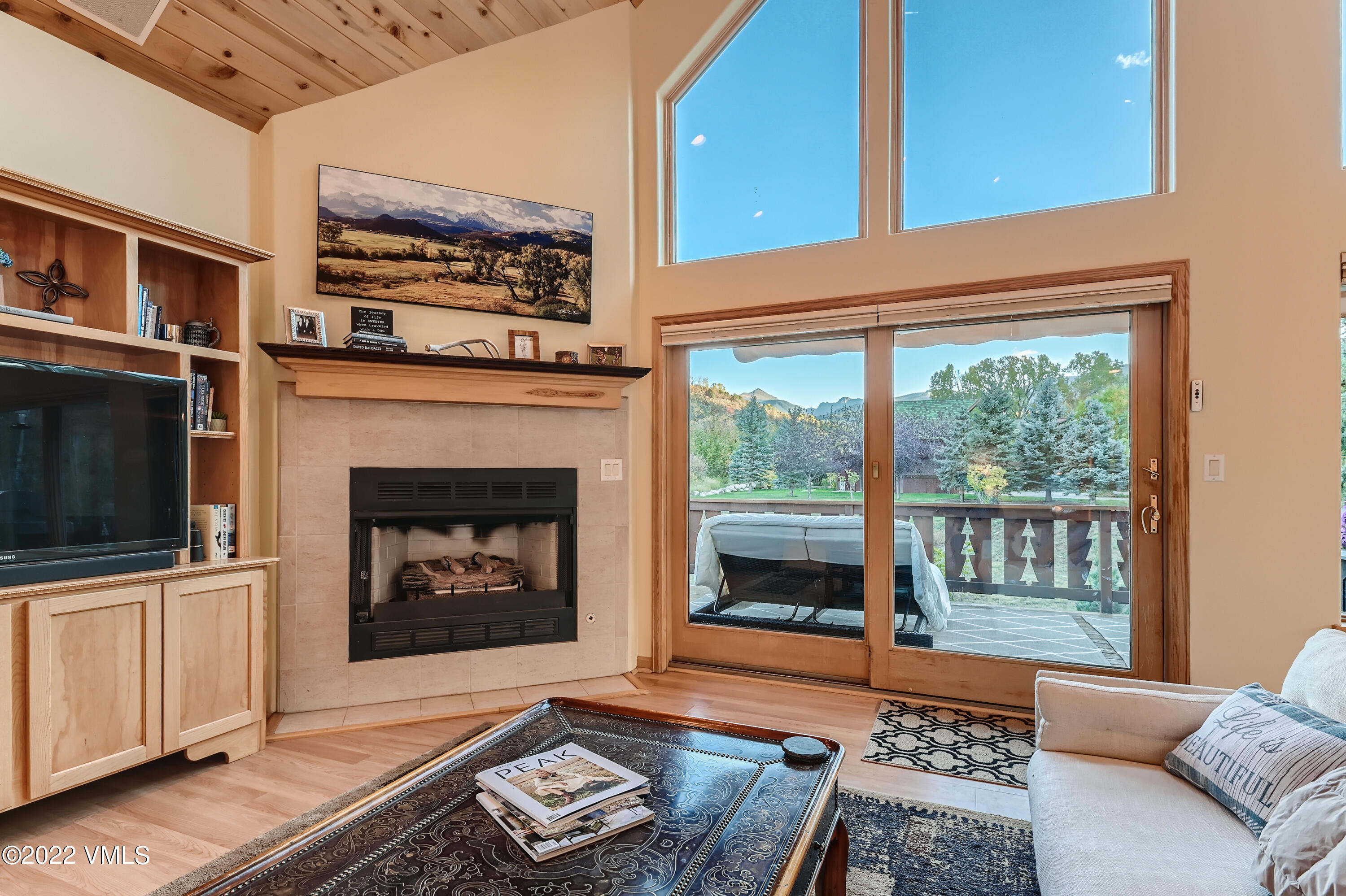 1476 Lake Creek Road Edwards, CO 81632 - Photo 12 of 35 a living room with furniture a flat screen tv and a fireplace