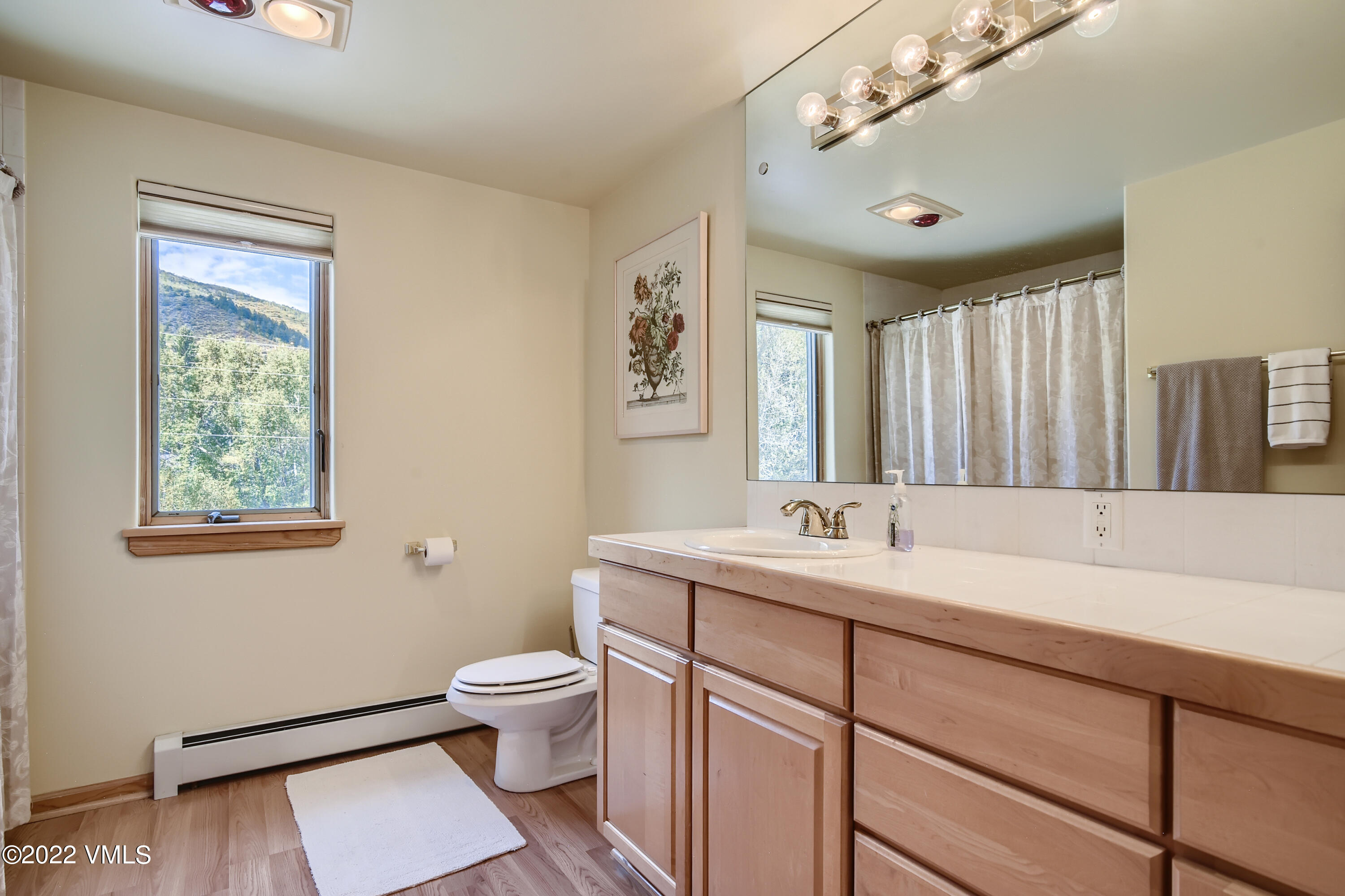 1476 Lake Creek Road Edwards, CO 81632 - Photo 15 of 35 a bathroom with a sink a toilet a mirror and a window