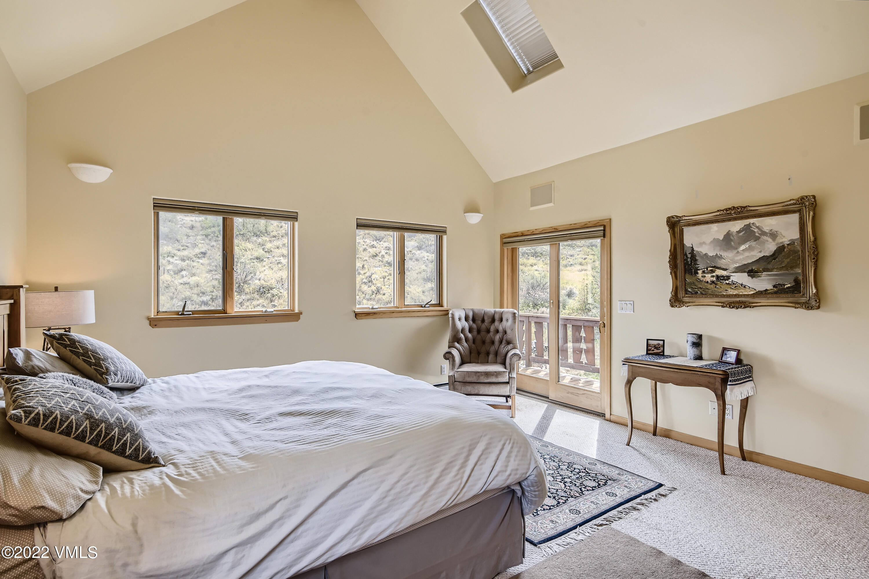 1476 Lake Creek Road Edwards, CO 81632 - Photo 16 of 35 a bedroom with a large bed a table and chair