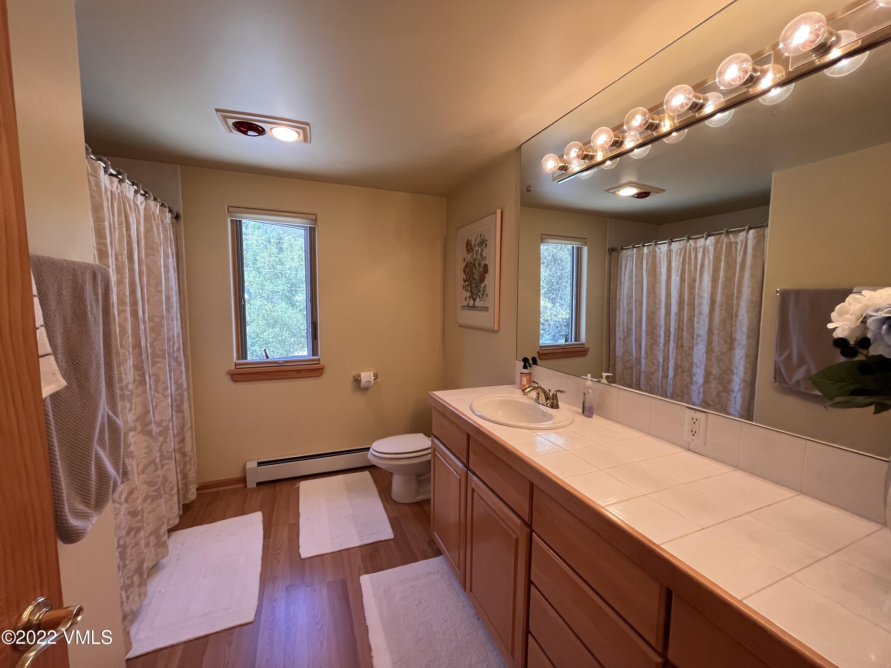 1476 Lake Creek Road Edwards, CO 81632 - Photo 19 of 35 a bathroom with a sink a large mirror and vanity