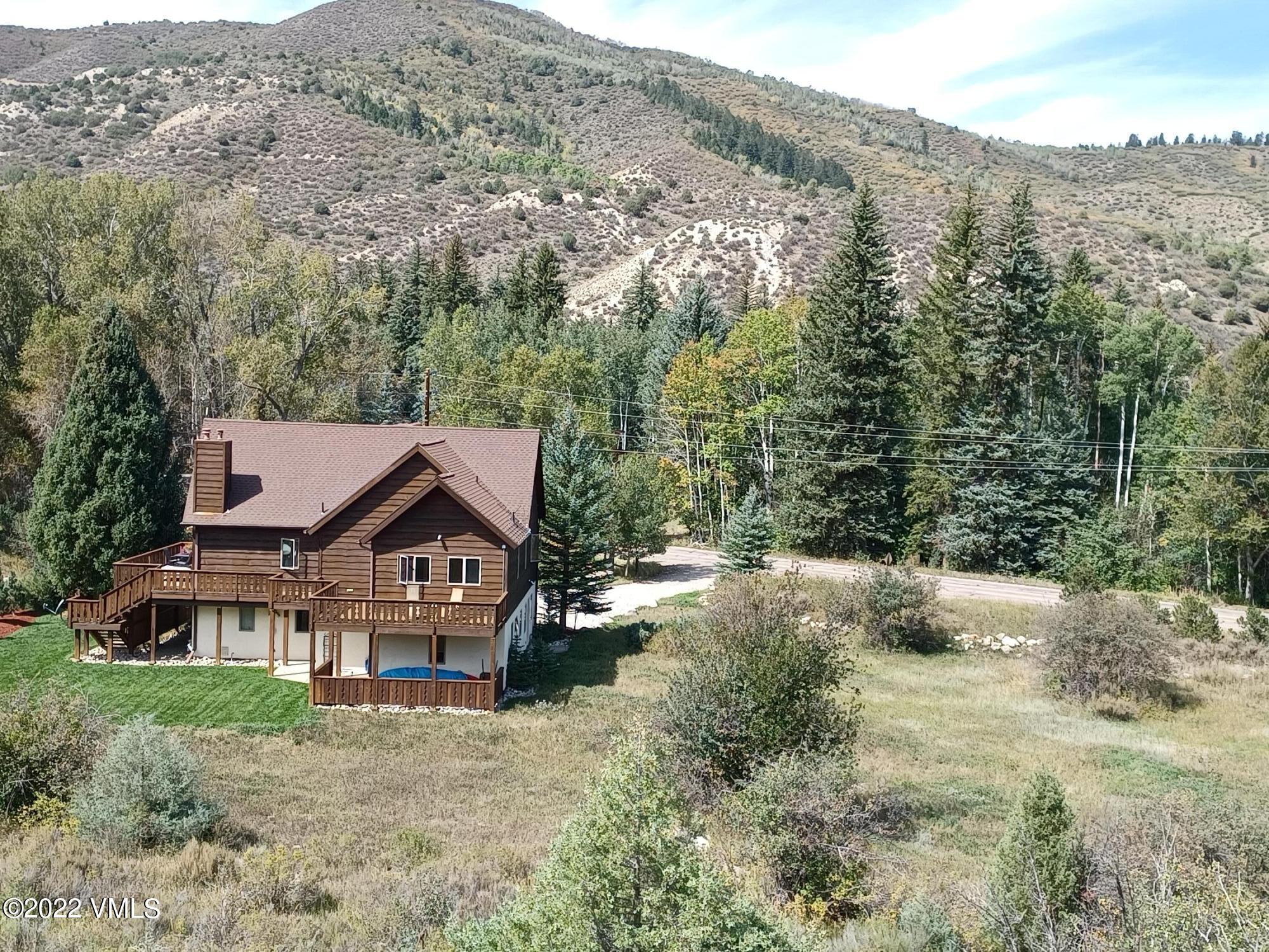 1476 Lake Creek Road Edwards, CO 81632 - Photo 33 of 35 a front view of a house with a yard and mountain