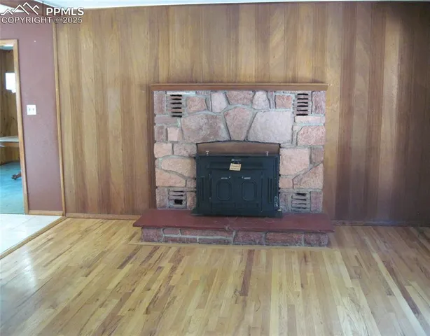 a room with a bed and a fireplace