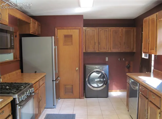 a kitchen with a refrigerator and a stove top oven