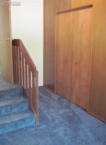 a view of a hallway with wooden floor and entryway