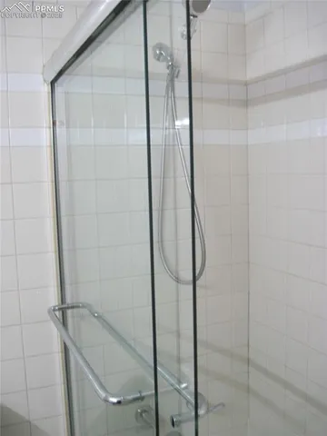 a bathroom with a glass shower door