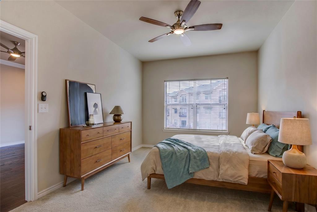 3102 Kings Road, Unit 2208 Dallas, TX 75219 - Photo 11 of 25 a bedroom with a bed and a chandelier