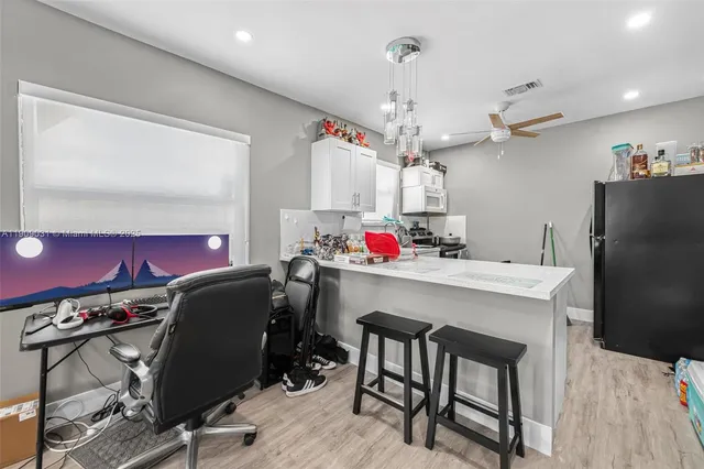 a view of a dining room with furniture and a chandelier