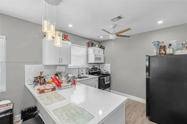 a very nice looking open with kitchen island of the furniture