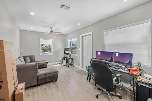 a living room with furniture and a wooden floor