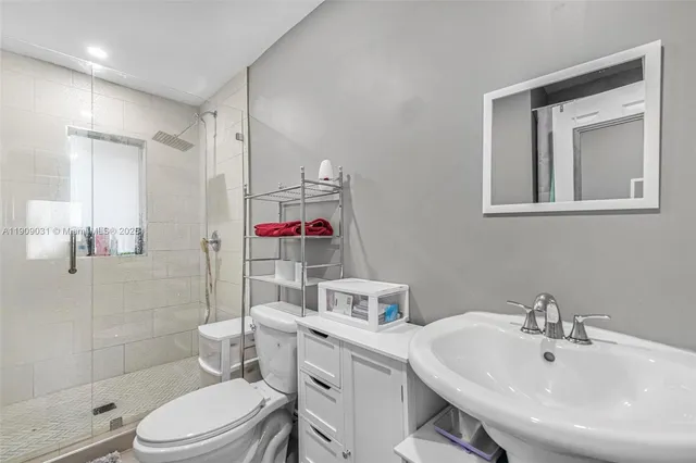 a bathroom with a sink toilet and shower