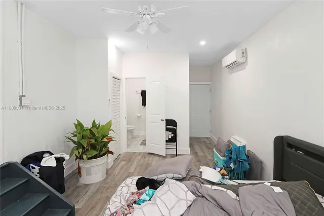 a bed room with a bed and a potted plant