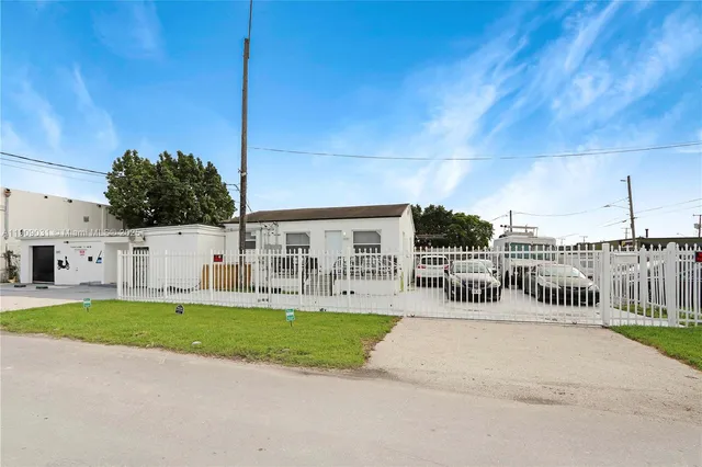 a view of a house with a patio and a yard