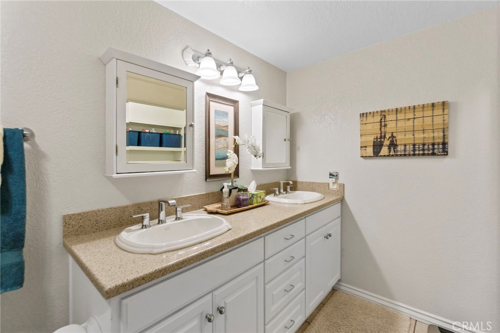 25752 View Pointe, Unit 3B Lake Forest, CA 92630 - Photo 14 of 22 a bathroom with a granite countertop sink and a mirror