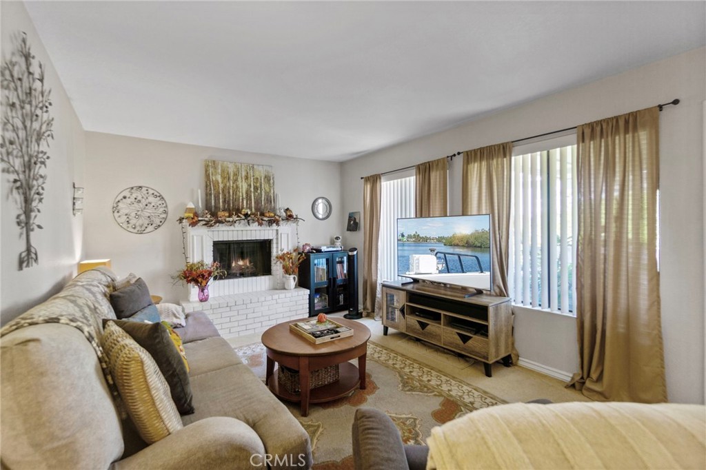 25752 View Pointe, Unit 3B Lake Forest, CA 92630 - Photo 6 of 22 a living room with furniture and a fireplace