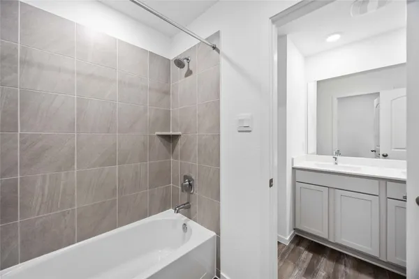 a white bath tub sitting next to a white sink