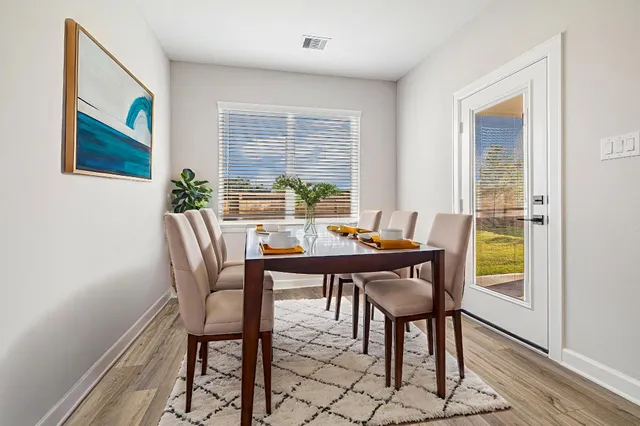 a view of a dining room with furniture window and wooden floor
