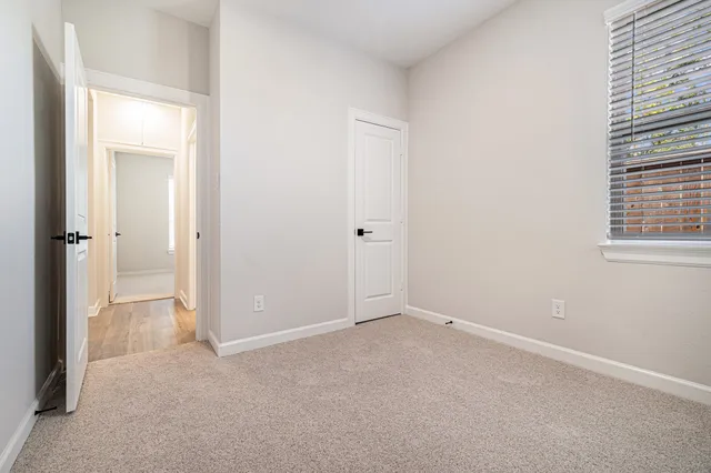 an empty room with windows and closet
