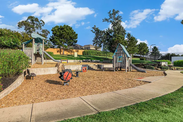 a backyard of a house with table and chairs plants