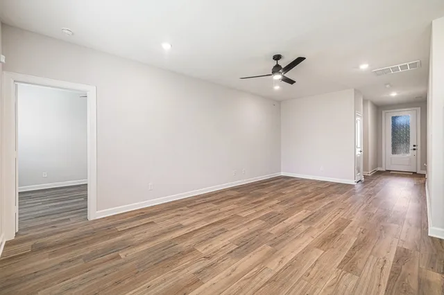 wooden floor in an empty room with a window