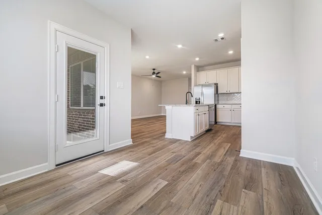 a view of a kitchen with a sink and a refrigerator