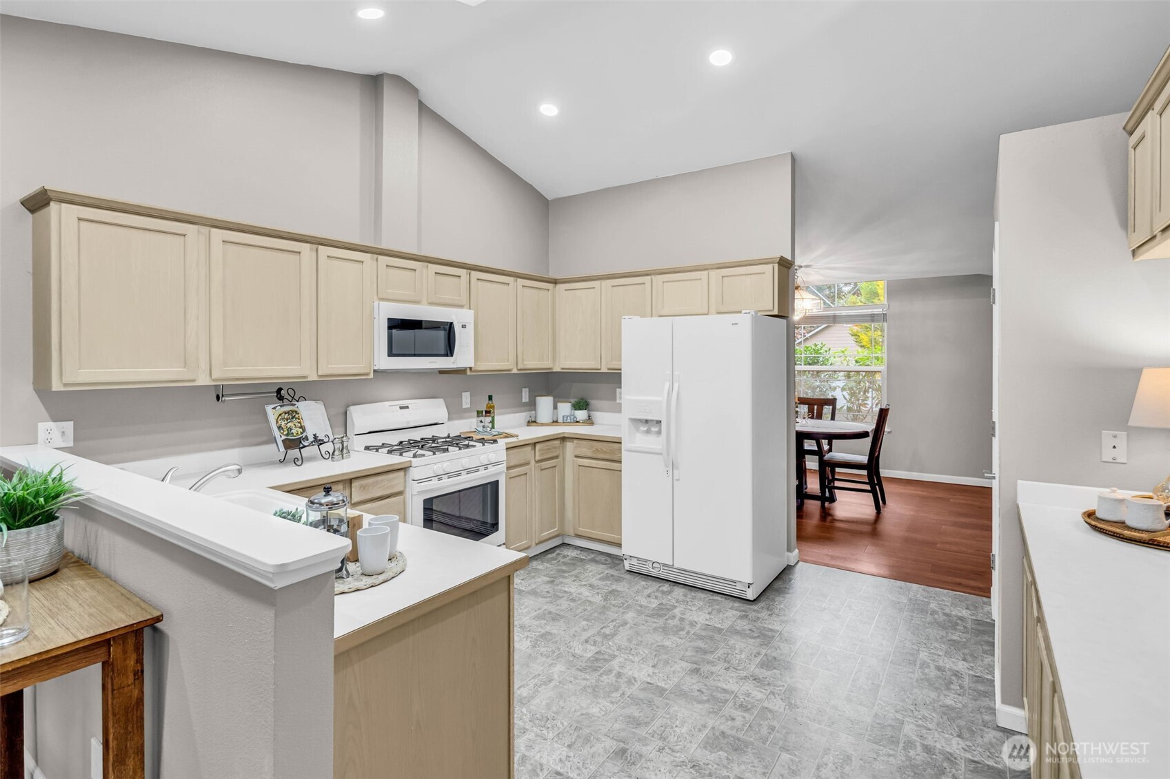 3212 200th Place Southeast Bothell, WA 98012 - Photo 12 of 40 a view of kitchen with refrigerator stove microwave and cabinets
