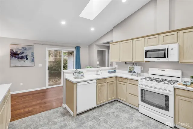 a kitchen with a stove sink and microwave