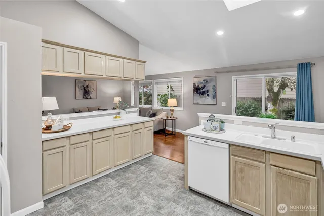 a kitchen with sink stove and cabinets