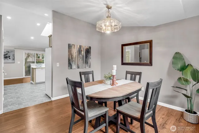 a view of a dining room with furniture and chandelier