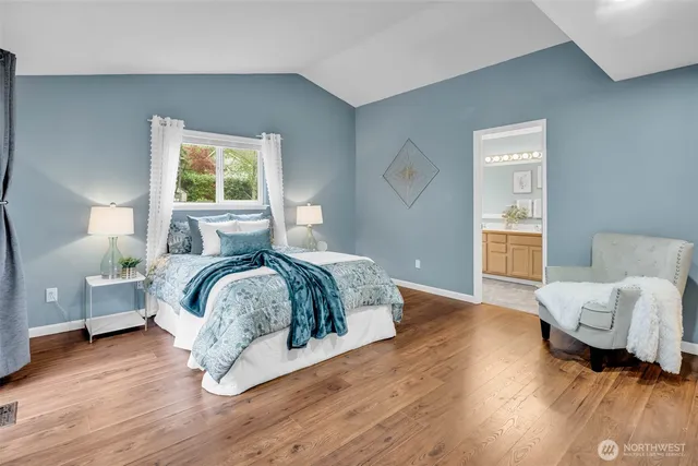 a bedroom with a bed and wooden floor