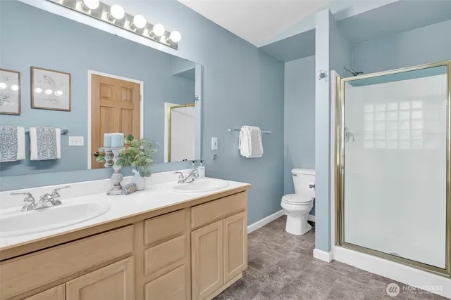 a bathroom with a toilet a sink and a large mirror