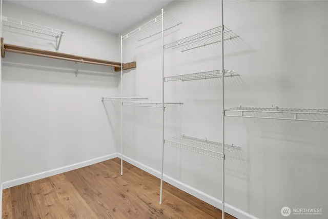 a view of a room with wooden floor