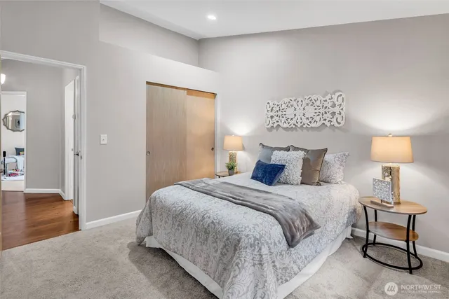 a bedroom with a bed and a lamp